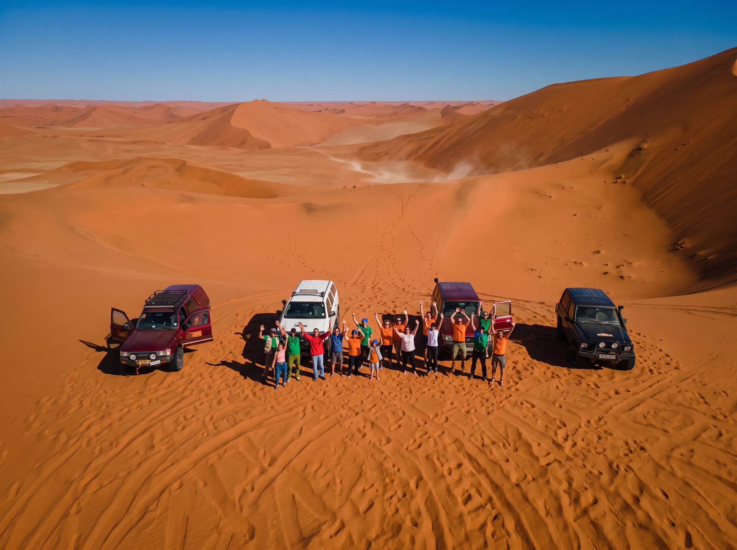 Yassine with travellers on the dunes